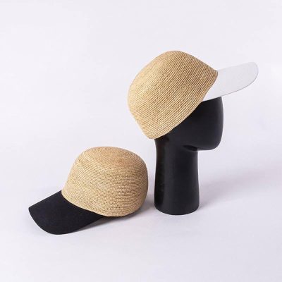 Sun hat with wide white brim and beige woven crown, stylish accessory for summer; perfect for outdoor sun protection and fashion.