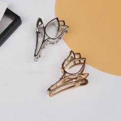 Elegant metal hair clips in silver and gold finishes displayed on a white surface, perfect for stylish hair accessories. Ideal for enhancing your hairdo with a chic, modern touch.