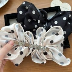 Polka dot silk hair bow, black and white, elegant hair accessory from Monalisa Store, perfect for special occasions and stylish hair styling.