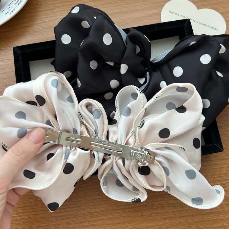 Polka dot silk hair bow, black and white, elegant hair accessory from Monalisa Store, perfect for special occasions and stylish hair styling.