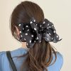 Polka dot black satin hair scrunchie for women's fashion and accessories.