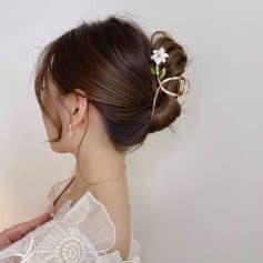 Elegant updo hairstyle with floral hair accessories for women visiting Monalisa Store for optical and beauty accessories.