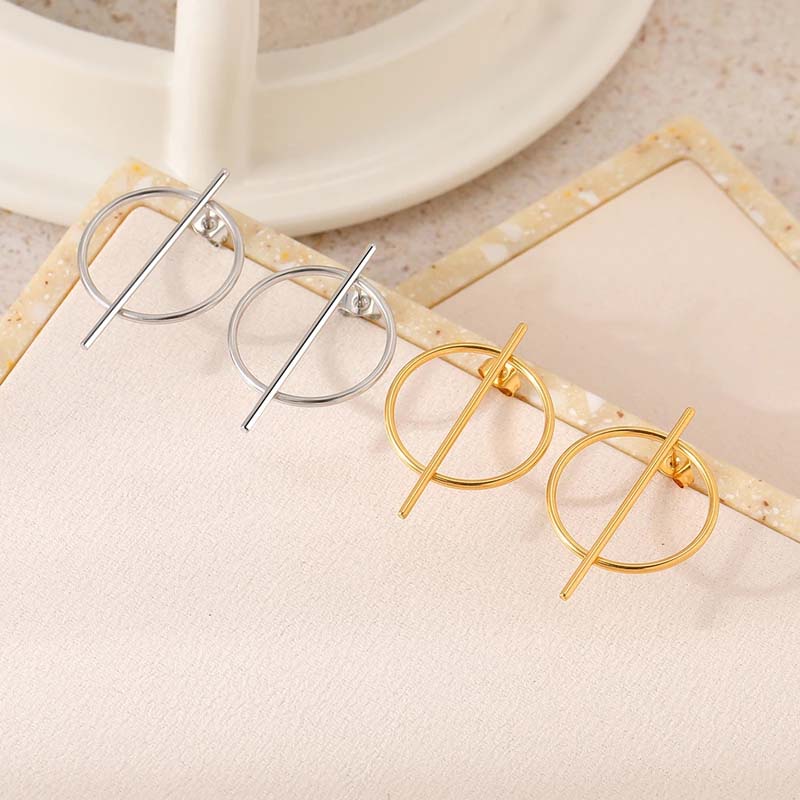 Sterling silver and gold hoop earrings with unique bar design, perfect for modern fashion accessories.