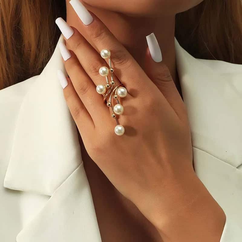 Elegant pearl and gold ring with multiple pearl accents, perfect for sophisticated jewelry collection.