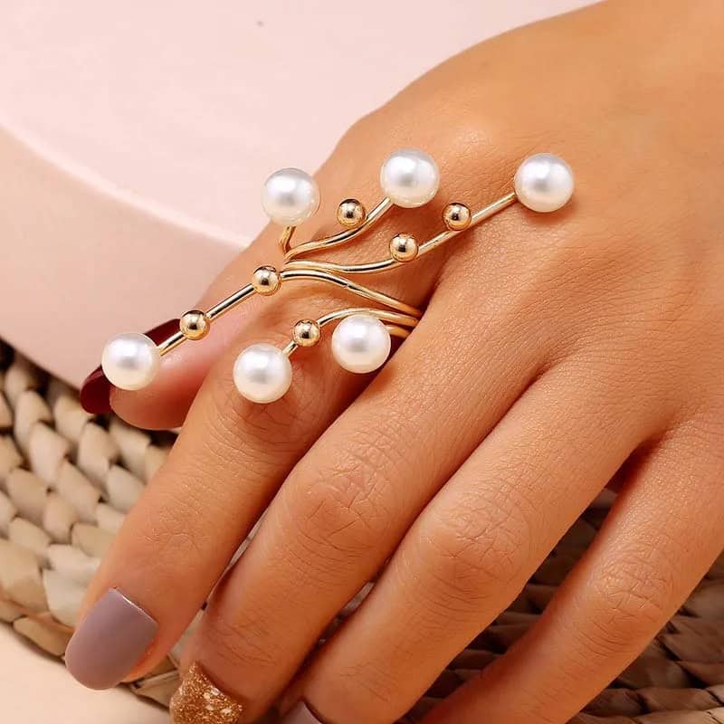 Elegant pearl and gold-tone statement ring, perfect for fashion-forward accessories and luxury jewelry collections.