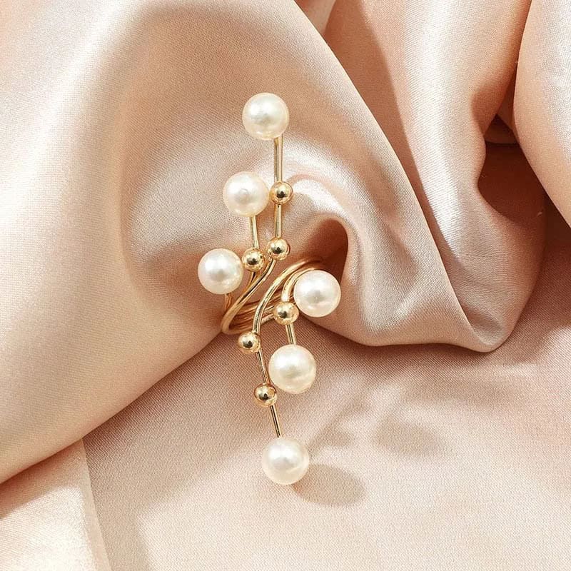 Elegant pearl and gold earrings displayed on soft satin fabric, perfect for stylish accessories and jewelry shopping at Monalisa Store.