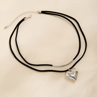Black choker necklace with a silver heart pendant, stylish and trendy jewelry perfect for fashion accessories.