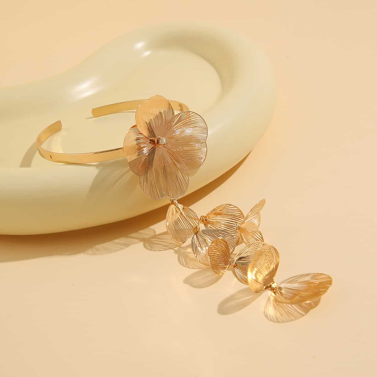 Elegant gold floral jewelry set featuring a bracelet and matching earrings, perfect for stylish accessories and gift options at Monalisa Store.