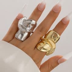 Shiny silver and gold statement rings on fingers, elegant jewelry fashion, Monalisa Medical Store, luxury accessories, modern jewelry design.