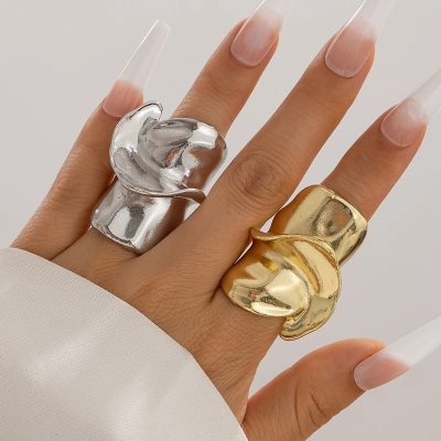 Shiny silver and gold statement rings on fingers, elegant jewelry fashion, Monalisa Medical Store, luxury accessories, modern jewelry design.