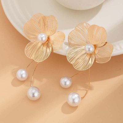Elegant gold flower earrings with pearl accents, perfect for jewelry lovers and special occasions, showcasing intricate design and luxurious style.