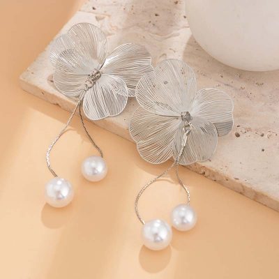 Delicate silver flower earrings with pearl drop accents, perfect for elegant jewelry and optical accessories collections.