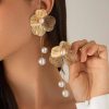 Elegant gold flower earrings with pearl accents, perfect for stylish accessories at Monalisa Store for fashionable women's jewelry.