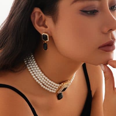 Elegant jewelry featuring black gemstone earrings, a pearl necklace, and a statement pendant, showcasing luxurious accessories from Monalisa Medical Store for stylish women.