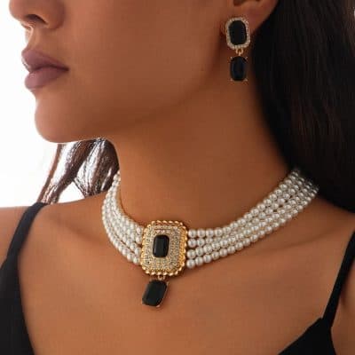 Luxurious black gemstone jewelry set, featuring pearl necklace and matching earrings, designed for elegant women seeking high-end jewelry for special occasions or fashion statements.