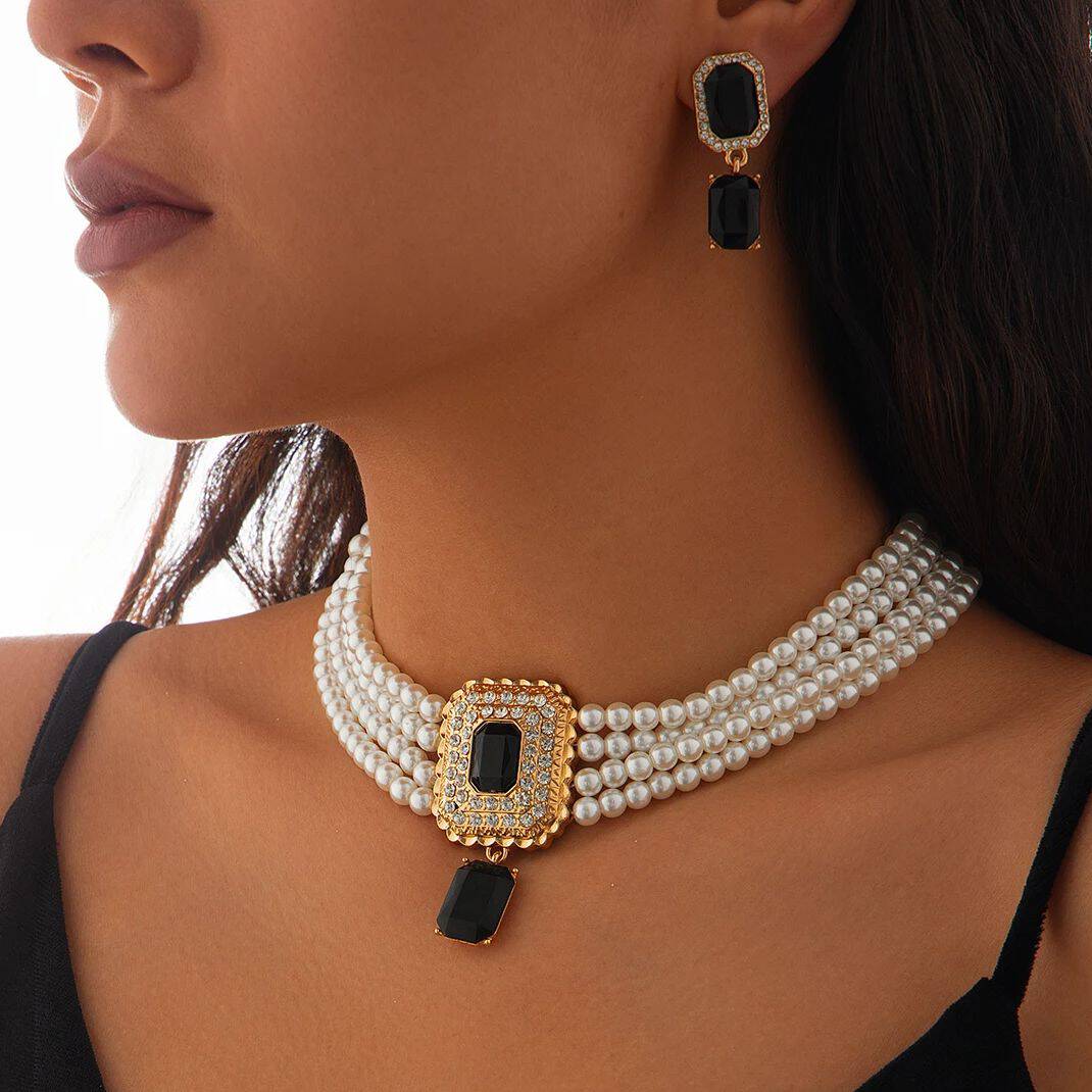 Luxurious black gemstone jewelry set, featuring pearl necklace and matching earrings, designed for elegant women seeking high-end jewelry for special occasions or fashion statements.