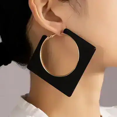 Gold and black geometric statement earring with circular design for women.