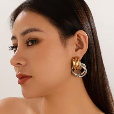 Elegant gold and silver statement earrings featuring intertwined hoops, showcasing contemporary jewelry styles available at Monalisa Store for modern fashion accessories.