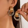 Demiurgic Collection bold two-tone metal hoop earrings featuring gold and silver intertwined loops, perfect as fashionable accessories for trendy women.