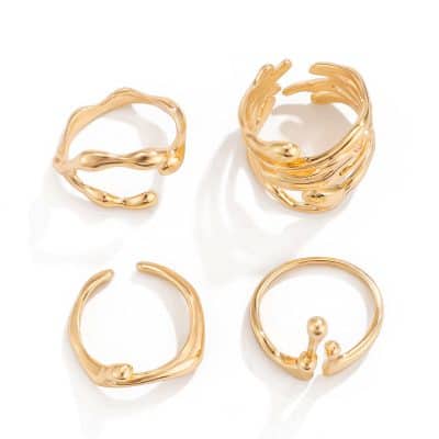 Shiny gold fashion rings and earrings with modern, artistic designs, perfect for stylish accessories and jewelry collections.