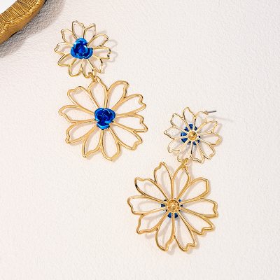 Gold flower-shaped jewelry with blue accents, elegant and fashionable accessory for women.