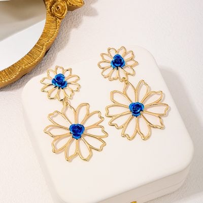 Elegant gold and blue floral earrings with intricate openwork design, perfect for stylish accessory collections.