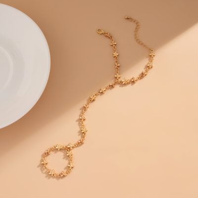 Elegant gold jewelry necklace adorned with small floral designs, perfect for everyday wear or special occasions. Crafted with high-quality materials for a timeless look.