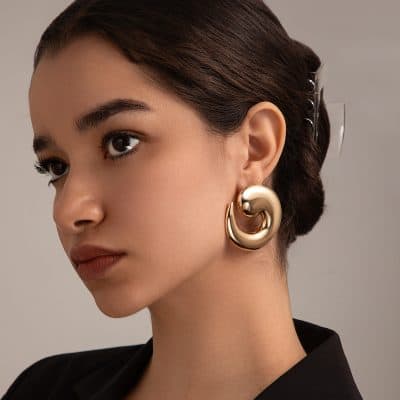 Luxurious gold statement earring worn by a stylish woman, showcasing elegant fashion accessories at Monalisa Store, perfect for enhancing your overall look and designed for modern elegance.