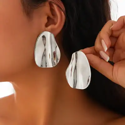 Silver abstract statement earrings with bold, artistic design for modern fashion and accessories. Perfect for elevate your style with unique jewelry pieces.