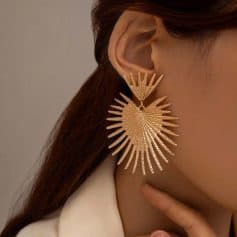 Elegant gold sunburst chandelier earring, perfect for stylish women looking for statement jewelry. Unique design adds glamour to any outfit for special occasions or everyday wear.
