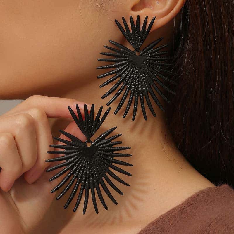 Stylish black sunburst earrings on a woman's ear, perfect for fashion-forward accessories. Ideal for enhancing your look with bold, statement jewelry pieces from Monalisa Store.