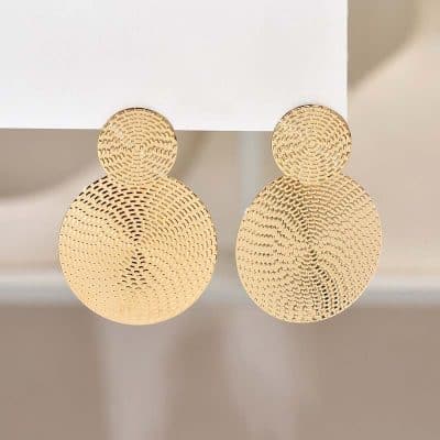 Two pairs of round, textured gold earrings with intricate perforated patterns, displayed on a white stand, showcasing elegant jewelry options at Monalisa Store for fashion-conscious customers.