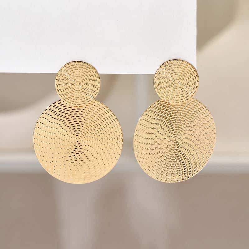 Two pairs of round, textured gold earrings with intricate perforated patterns, displayed on a white stand, showcasing elegant jewelry options at Monalisa Store for fashion-conscious customers.
