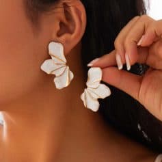 Elegant white floral statement earrings with gold accents, perfect for sophisticated fashion and special occasions. Shop stylish jewelry at Monalisa Store for a unique look.