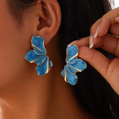 Blue butterfly-shaped earrings with gold accents, perfect for stylish accessories and looks.