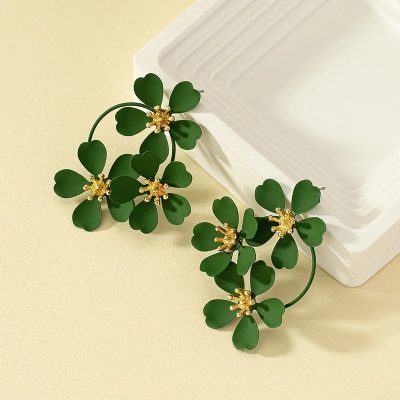 Elegant green four-leaf clover jewelry earrings with gold accents and rhinestones, perfect for St. Patrick's Day or lucky charm accessories.