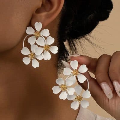 Elegant white floral statement earrings with gold accents, perfect for special occasions and fashion-forward looks. Explore Monalisa Store's collection of stylish jewelry today.