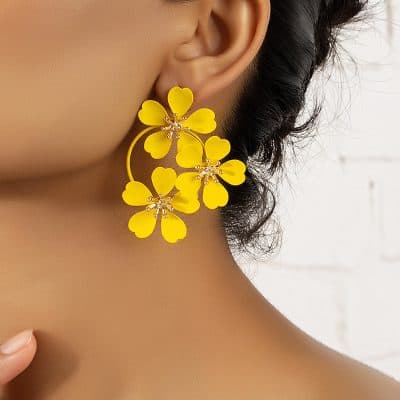 Bright yellow flower-shaped statement earrings with crystal accents, perfect for trendy accessories and jewelry fashion. Ideal for bold jewelry lovers and stylish women.