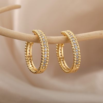 Elegant gold hoop earrings with sparkling cubic zirconia stones, perfect for women's jewelry collections and special occasions.