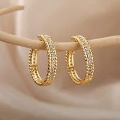 Delicate gold hoop earrings adorned with sparkling cubic zirconia stones, perfect for enhancing your jewelry collection and elevating your elegant or casual look.