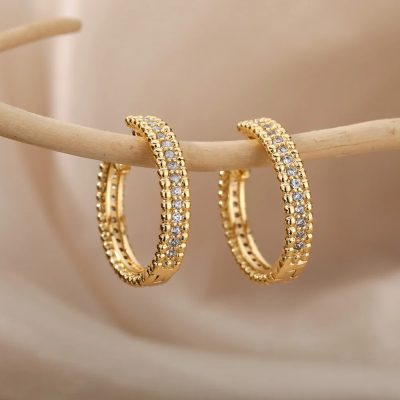 Delicate gold hoop earrings adorned with sparkling cubic zirconia stones, perfect for enhancing your jewelry collection and elevating your elegant or casual look.