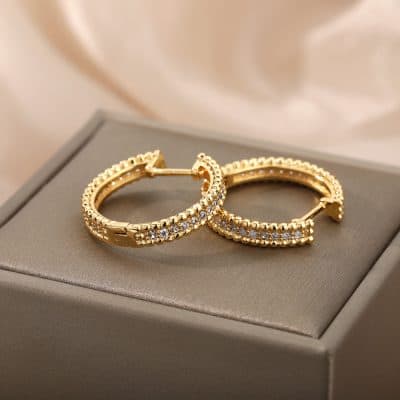 Dainty gold hoop earrings with embedded cubic zirconia, perfect for elegant jewelry collections or gifting at Monalisa Medical Store. Crafted with precision for a luxurious look.