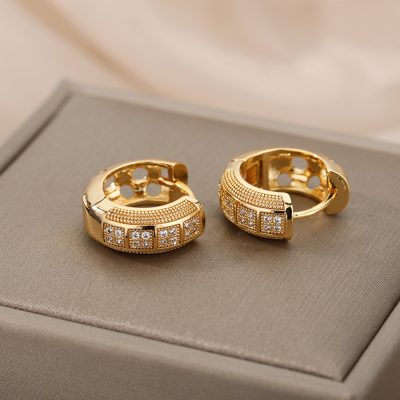 Elegant gold hoop earrings with embedded diamonds, perfect for luxury jewelry collections and fashionable accessories.