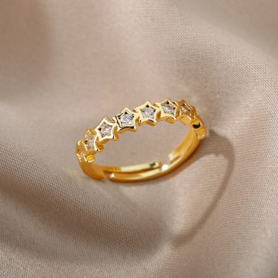 Dainty gold star-shaped ring with embedded diamonds, perfect for elegant jewelry collection.
