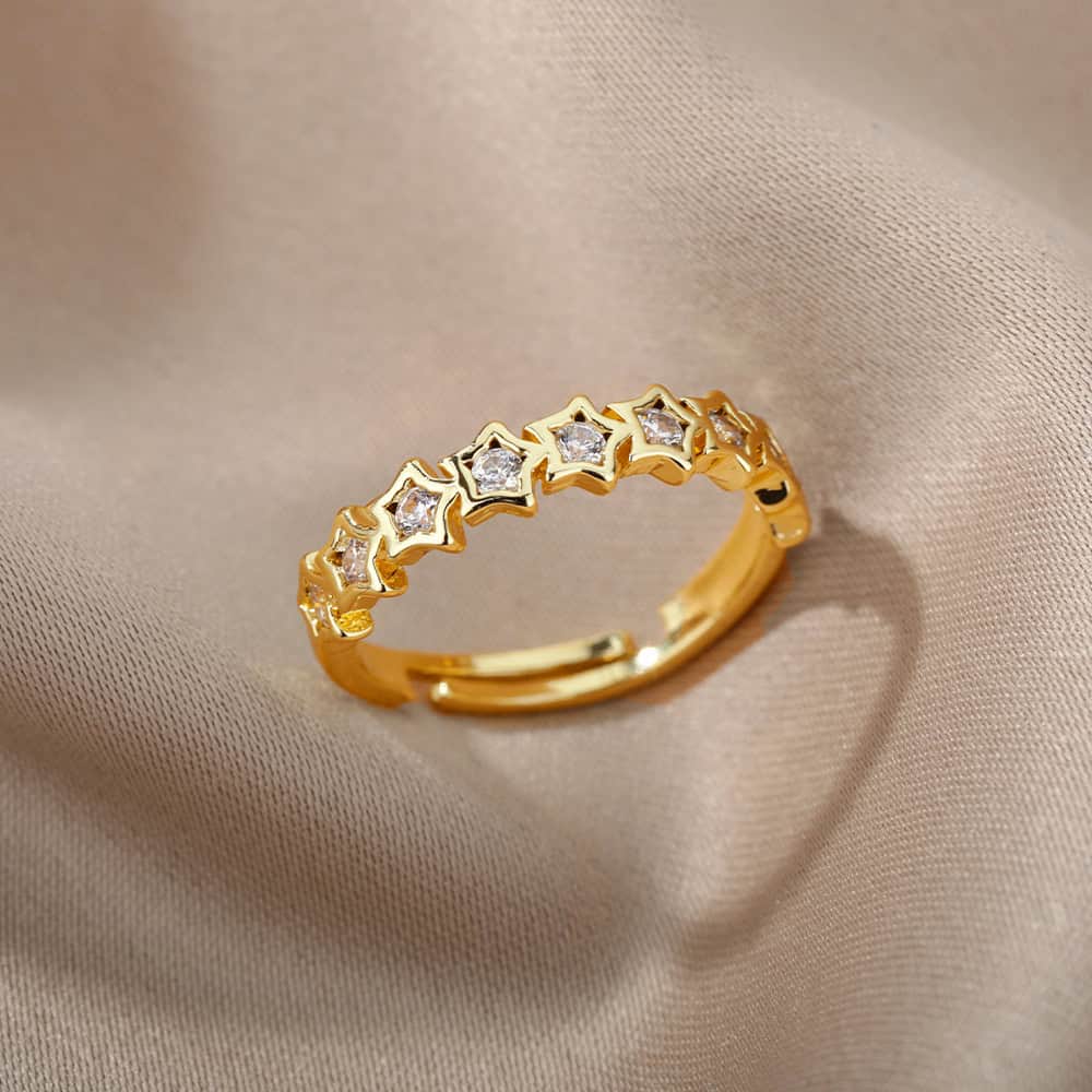 Dainty gold star-shaped ring with embedded diamonds, perfect for elegant jewelry collection.