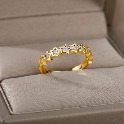 Dainty gold ring with star-shaped settings and sparkling diamonds, designed for elegant jewelry lovers. Ideal for special occasions or everyday wear, showcasing fine craftsmanship from Monalisa Store.