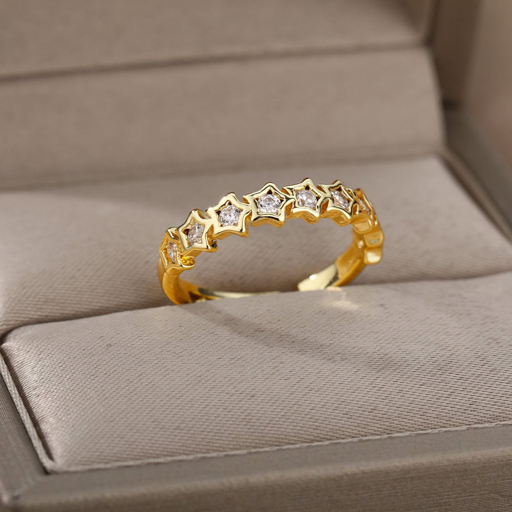 Dainty gold ring with star-shaped settings and sparkling diamonds, designed for elegant jewelry lovers. Ideal for special occasions or everyday wear, showcasing fine craftsmanship from Monalisa Store.
