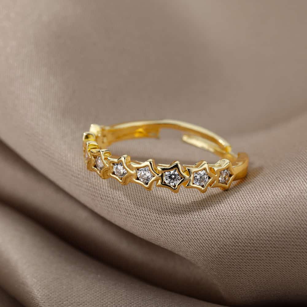 Delicate gold ring featuring star-shaped settings with sparkling diamonds, perfect for elegant jewelry collection or special occasions.