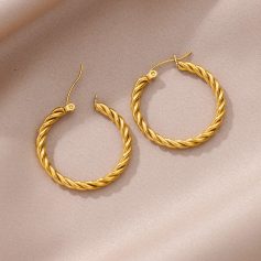 Elegant gold twisted hoop earrings with hook closure perfect for sophisticated jewelry styling.