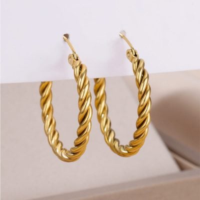 Shiny gold twisted hoop earrings displayed on white background, perfect for stylish accessories and jewelry shopping.